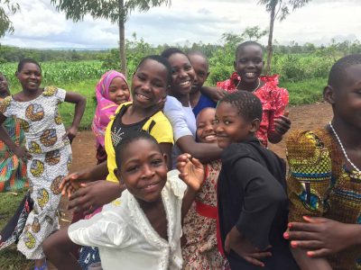 a group of girls at the Emmanuel Center smiling and posing playfully together